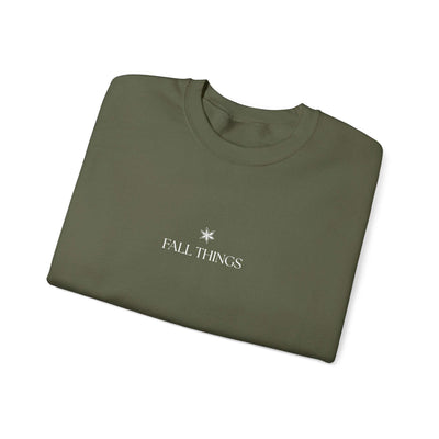 Folded olive green Fall Things Sweatshirt with minimalist white text and symbol on front crewneck design