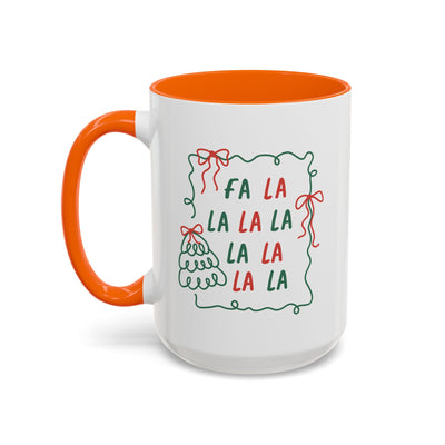 White ceramic Fa La La Christmas coffee mug with orange handle and interior, minimalist festive design with red and green lettering and holiday illustrations, dishwasher and microwave safe.