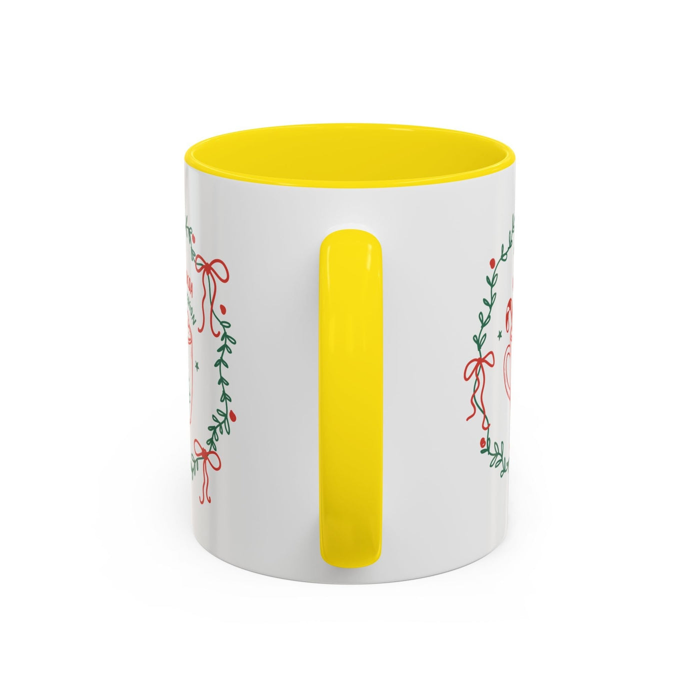White ceramic mug with yellow handle and interior, festive greenery and bow design, available in 11oz and 15oz sizes