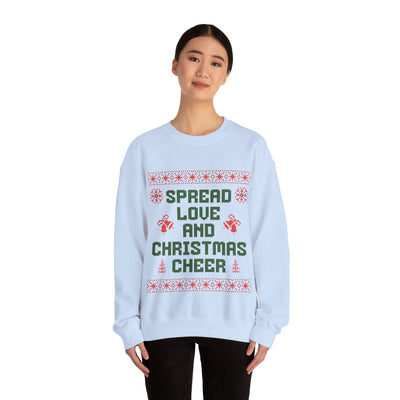 Woman wearing cozy white crewneck sweatshirt with "Spread Love and Christmas Cheer" holiday design