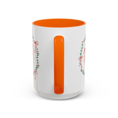 White ceramic mug with orange handle and interior, festive greenery design, available in 11oz and 15oz sizes