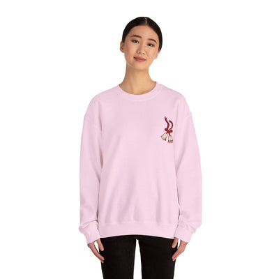 Woman wearing light pink vintage Merry Christmas crewneck sweatshirt with bell and Santa sleigh design by Brew’d Up Designs