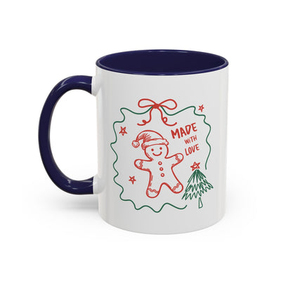 White ceramic festive Christmas coffee mug with blue handle and interior, decorated with red and green gingerbread man and "Made with Love" design