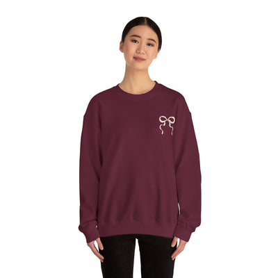 woman wearing maroon Coquette Christmas Faith Crewneck sweatshirt with bow design on chest