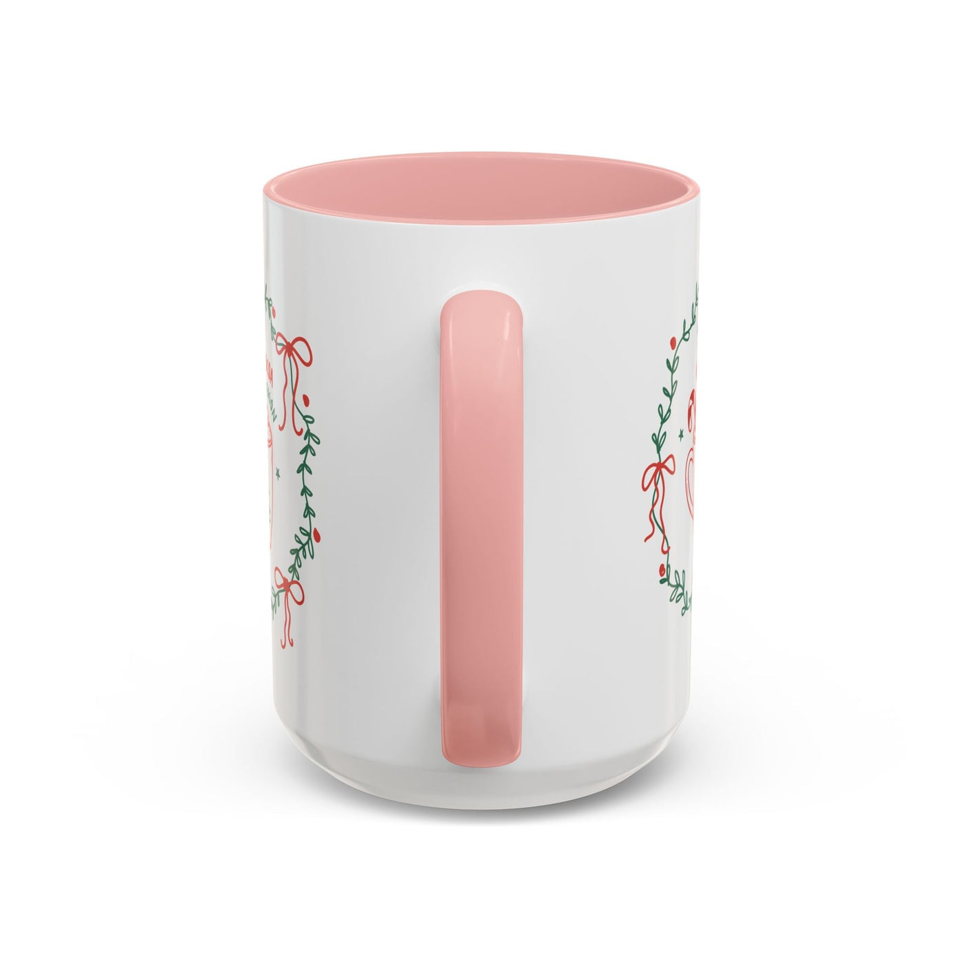 White ceramic mug with pink handle and interior featuring festive greenery and red ribbon design