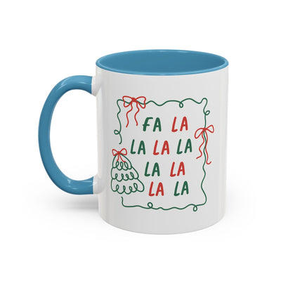 Fa La La Christmas Coffee Mug with blue handle and rim, minimalist holiday design in red and green on white ceramic, microwave and dishwasher safe.