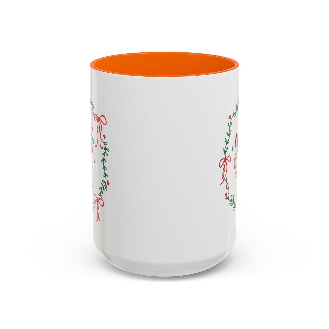White ceramic mug with orange interior and festive greenery design