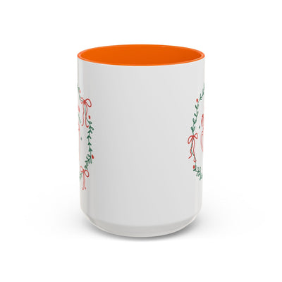 White ceramic mug with orange interior and festive greenery design