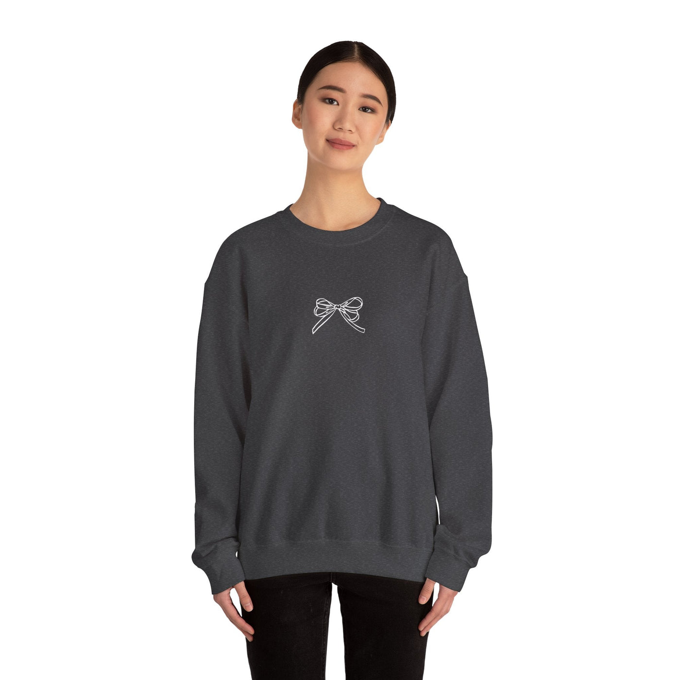 Woman wearing black Holiday Bow Crewneck Sweatshirt with bow design on front, festive cozy casual holiday top