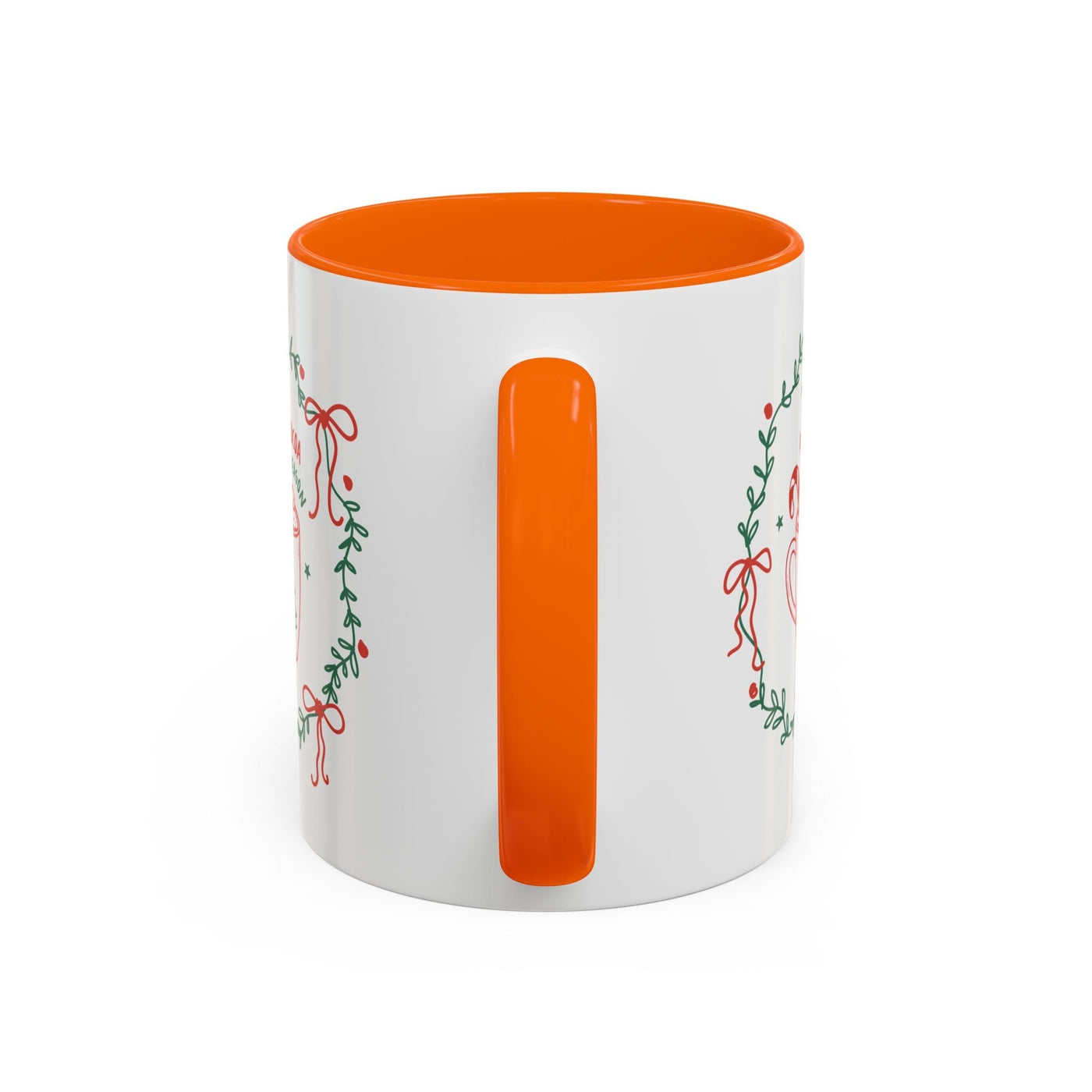 White ceramic mug with orange interior and handle featuring festive greenery and red ribbon design