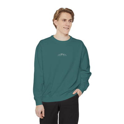 Unisex teal sweatshirt with mountain skiing embroidery and 'Apres Mode' text, relaxed fit, ribbed cuffs and hem.