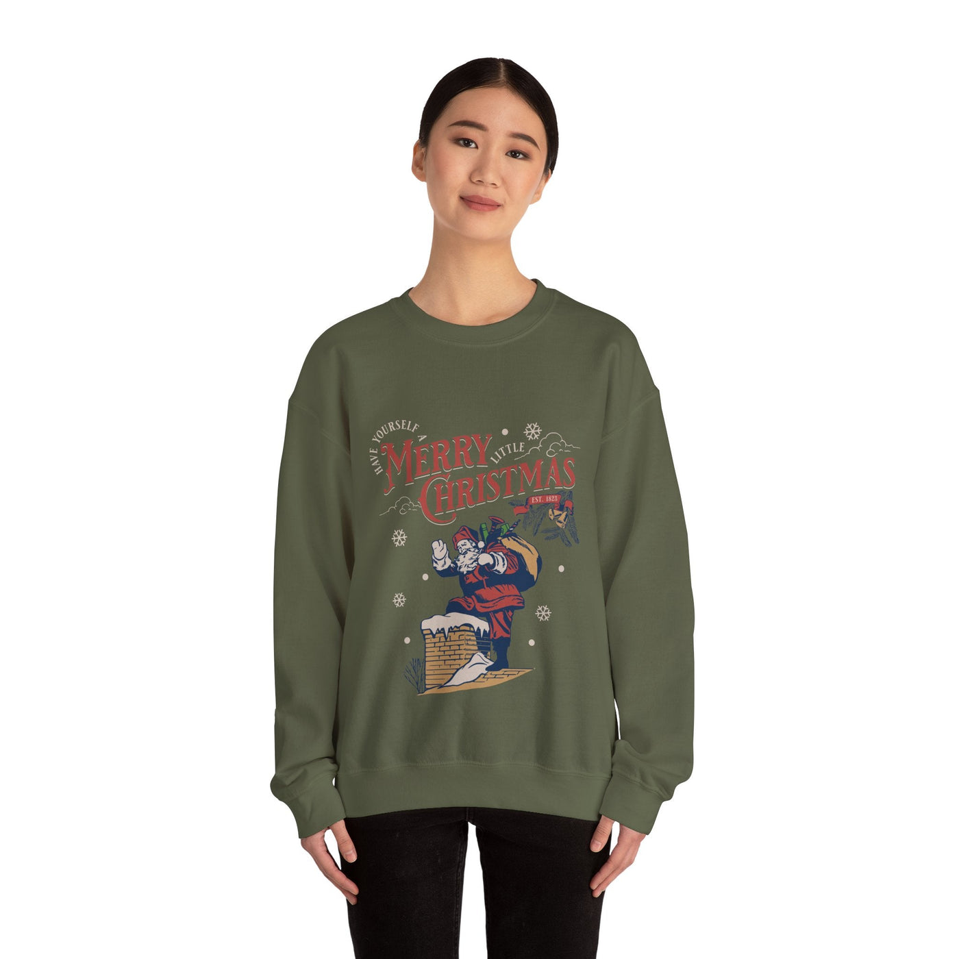 Woman wearing olive green vintage Santa crewneck sweatshirt with Santa climbing chimney graphic and Merry Christmas text