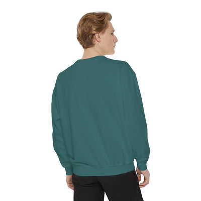 Man wearing cozy unisex garment-dyed sweatshirt with minimalist embroidery, shown from back.